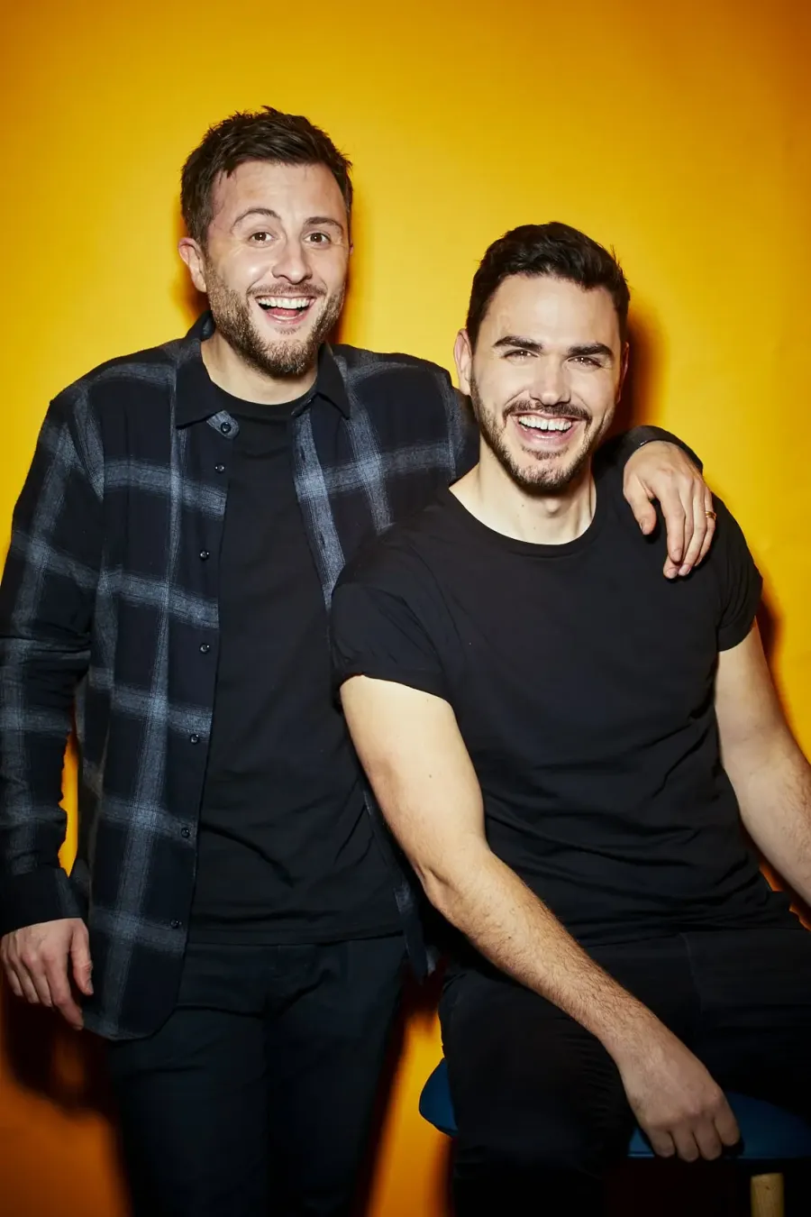 Two men (Henry and Ian) against a yellow background