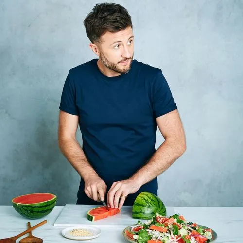 Photograph of IAN THEASBY cutting fruit