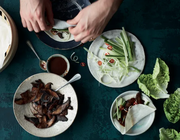 hands arranging food on plates