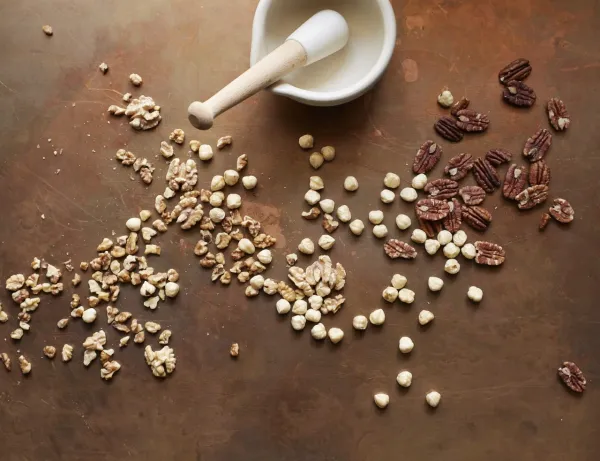 grains and seeds with a mortar and pestle